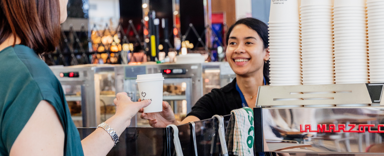 Person ordering coffee at Hudsons Coffee